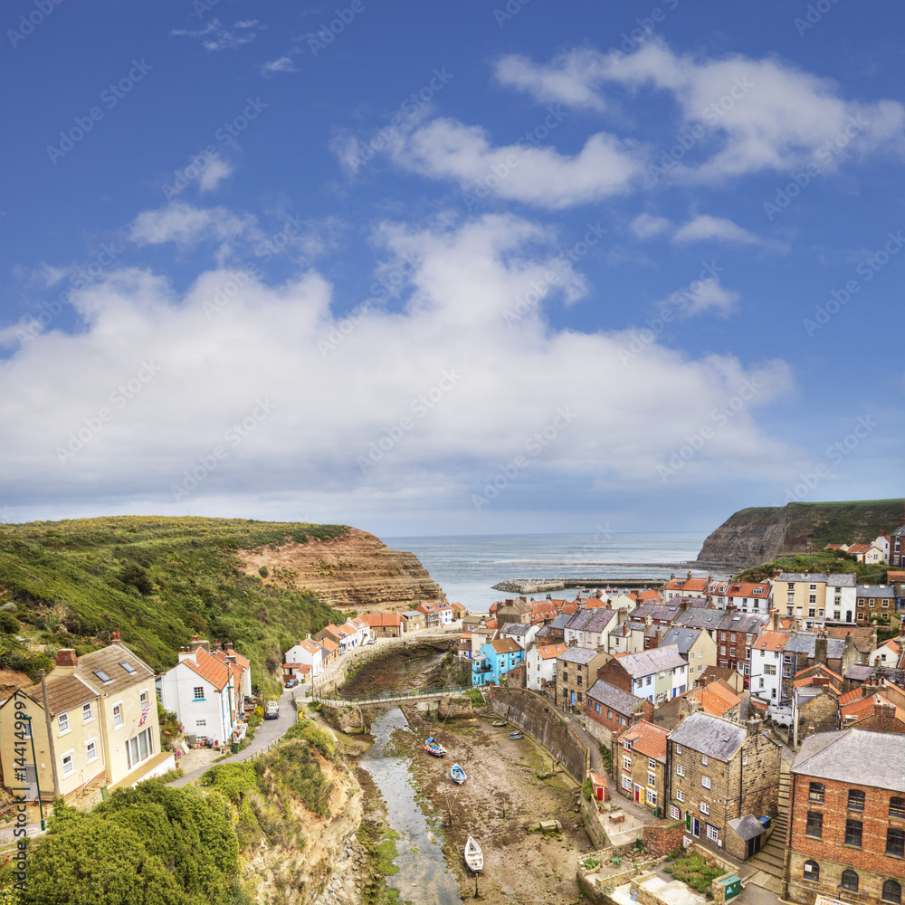 The tiny fishing village of Staithes and the Roxby Beck on the North Yorkshire coast, England The tiny fishing village of Staithes and the Roxby Beck on the North Yorkshire coast, England