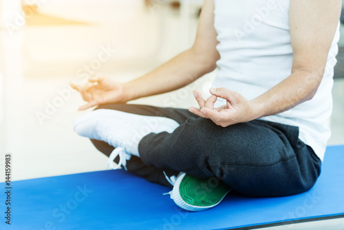 Asian senior man practicing yoga. Copy space. Meditating