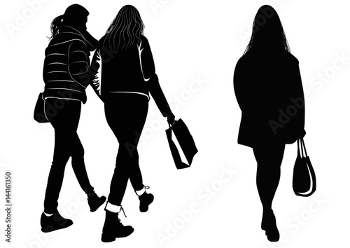 Silhouette of women walking with shopping bags