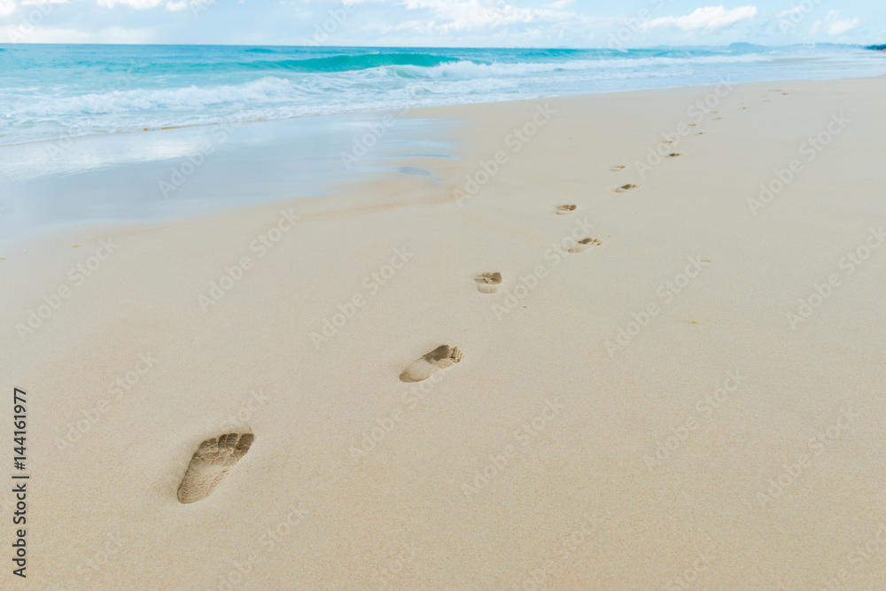 Beach, wave and footprints at sunset time Beach, wave and footprints at sunset time