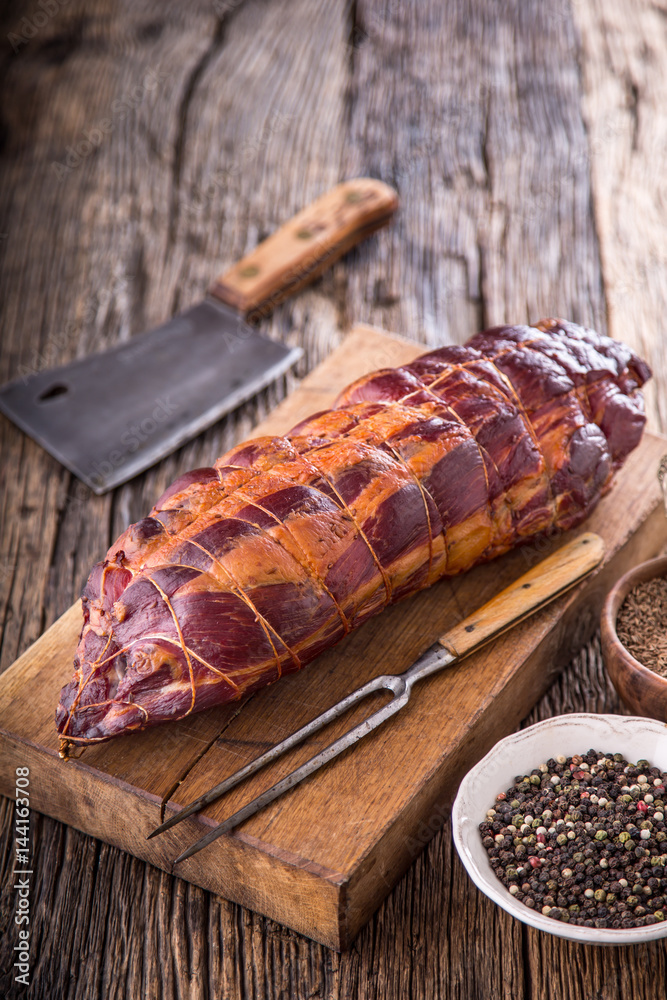 Fototapeta premium Pork meat.Pork chop smoked. Traditional smoked meat on oak wooden table in other positions.