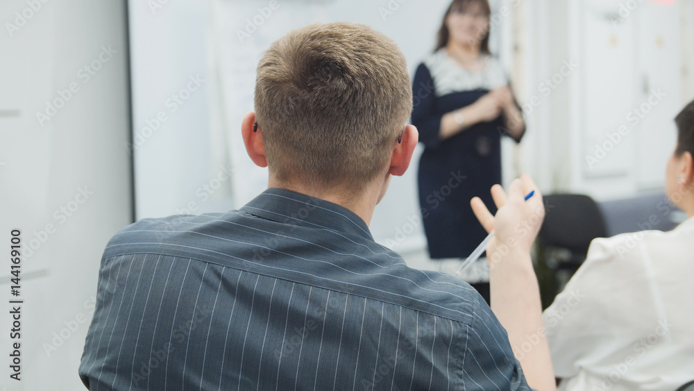 Fototapeta premium Business people - man at business seminar speaking with lecturer and audience - meeting concept