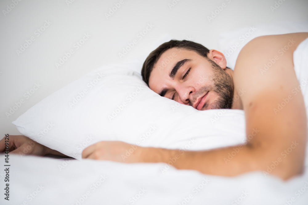 Handsome young man sleeping in white bed at his room at home Handsome young man sleeping in white bed at his room at home