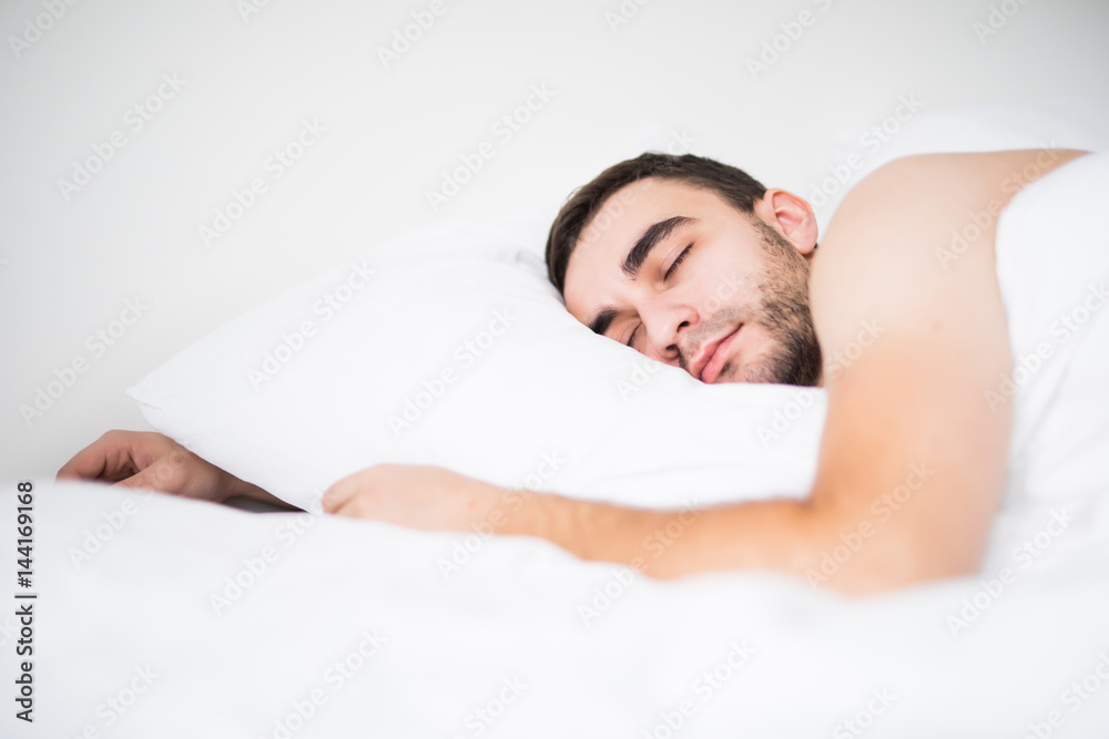 Young man sleeping in his bed, hug pillow, dreaming. Young man sleeping in his bed, hug pillow, dreaming.
