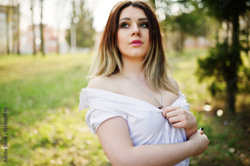 Portrait of girl with streaked hair, wear on white blouse, showing her shoulders. Portrait of girl with streaked hair, wear on white blouse, showing her shoulders.