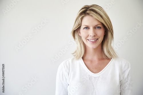 Blond and blue eyed beautiful woman smiling to camera © sanneberg