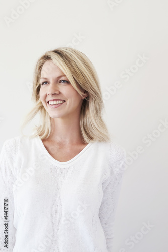 Blond beautiful woman smiling in studio