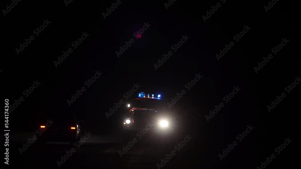 Car rescuers truck flashing blue lights at night, fire truck on road