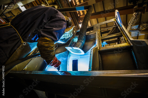 Welder at work in industrial surrondings. photo