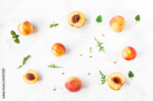 Fototapeta Naklejka Na Ścianę i Meble -  Fresh peaches. Sliced peaches on white background. Flat lay, top view