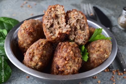 Meatballs with buckwheat in a metal bowl on a grey abstract background.Healthy food.Healthy eating concept photo