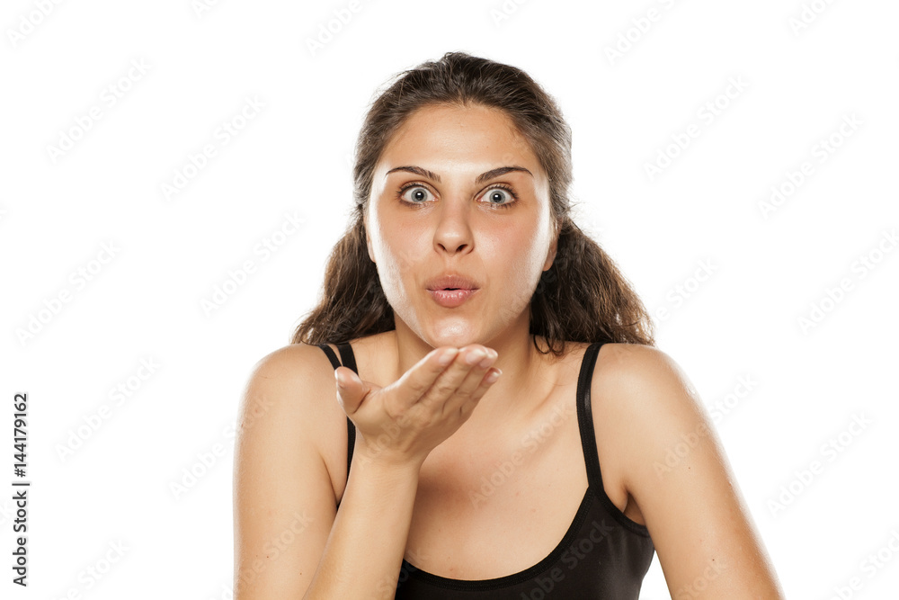 young beautiful woman blowing a kiss from the her hand young beautiful woman blowing a kiss from the her hand