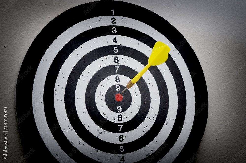 Yellow arrow on red center point on target board Yellow arrow on red center point on target board