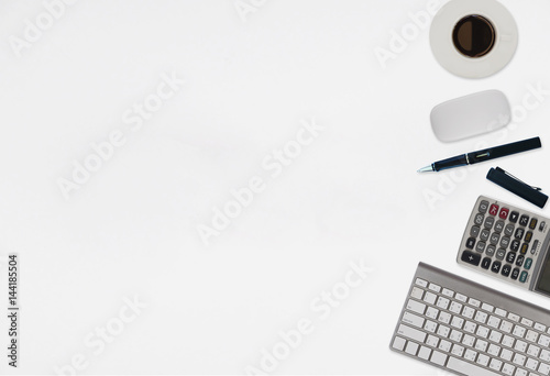 Office desk table with computer, supplies,analysis chart, calculator,coffee cup on wooden background. Top view with copy space