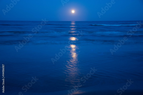 Sunset and the moon rising on the Mediterranean coast in southern Spain
