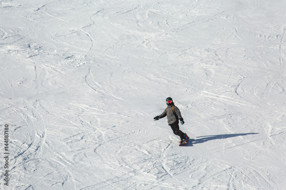 snowboarder snowboarding on fresh snow on ski slope on Sunny winter day in the ski resort in Georgia's