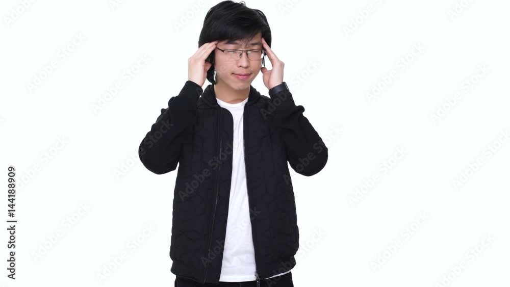 Young overworked asian man suffering from a strong migraine isolated over white background Young overworked asian man suffering from a strong migraine isolated over white background
