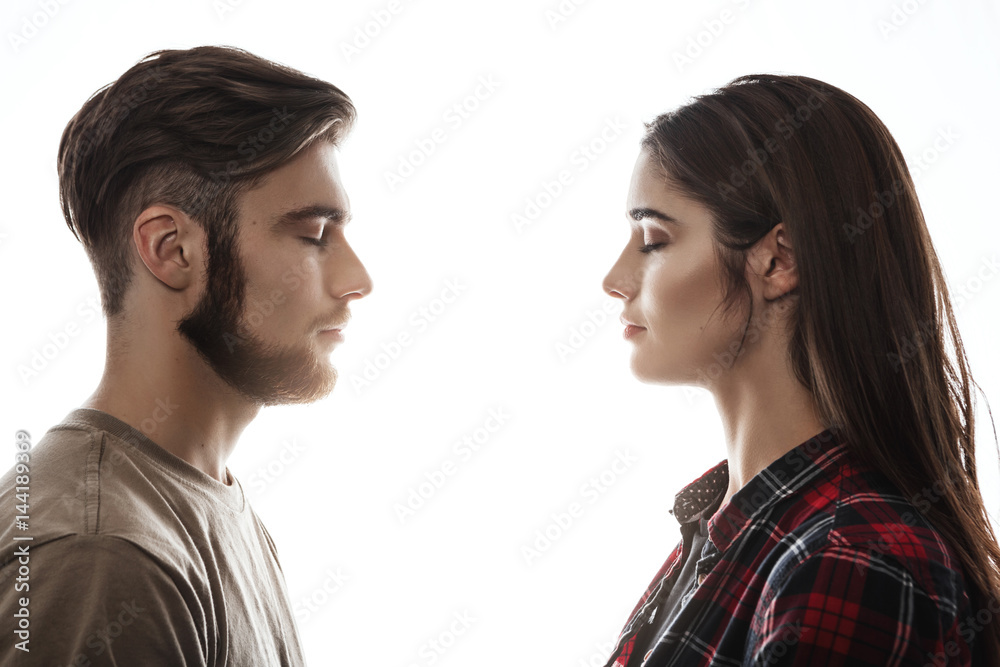 Side view. Man and woman facing each other, eyes closed. Side view. Man and woman facing each other, eyes closed.