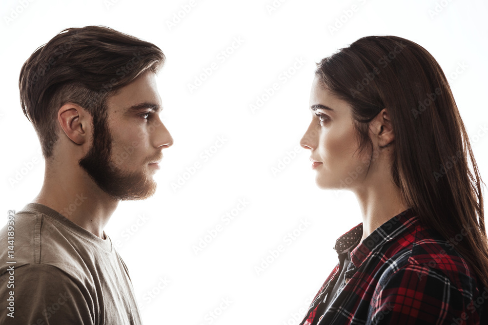 Side view. Man and woman facing each other, eyes open. Side view. Man and woman facing each other, eyes open.