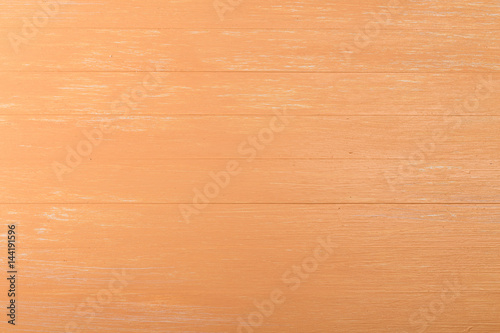 Orange wood background. Painted scraped wooden board. Bright texture or pattern.
