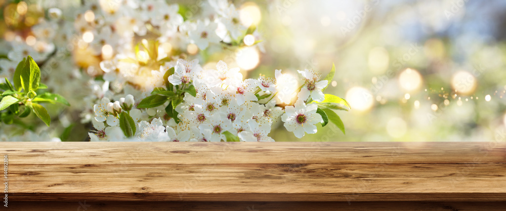 White blossoms in spring with wooden table White blossoms in spring with wooden table