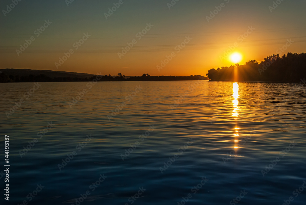 Beautiful sunset on the river, with blue sky and river