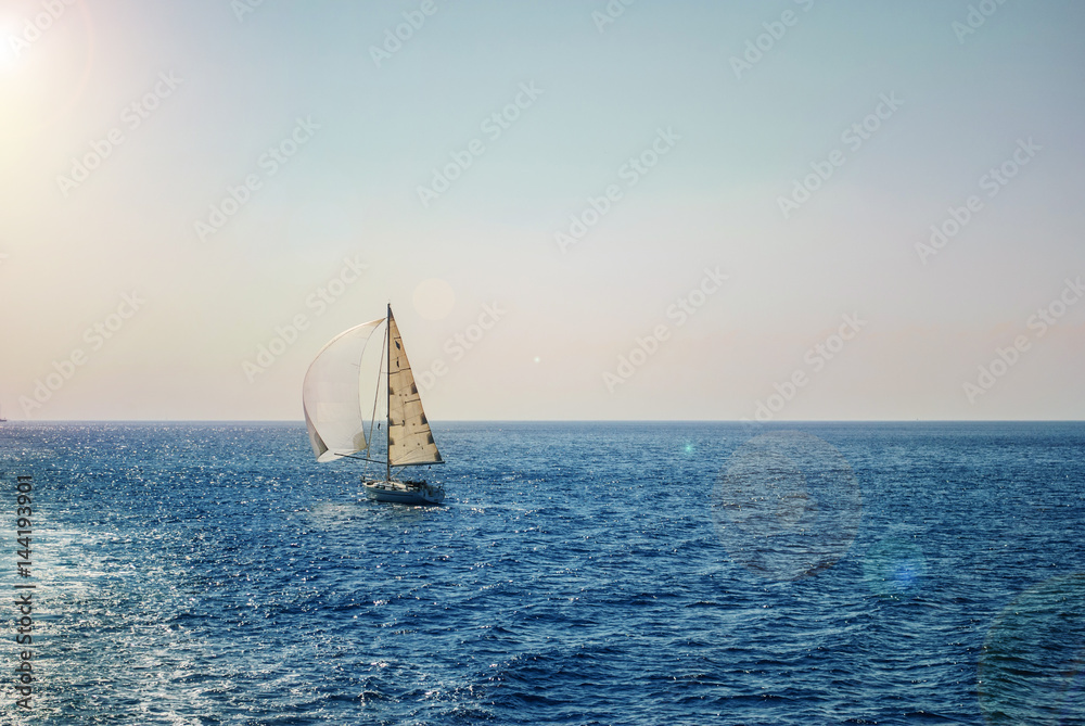 Yacht at sea, with pitched sails