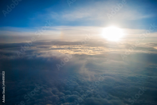 View of the sunrise and the clouds from within  out of the plane