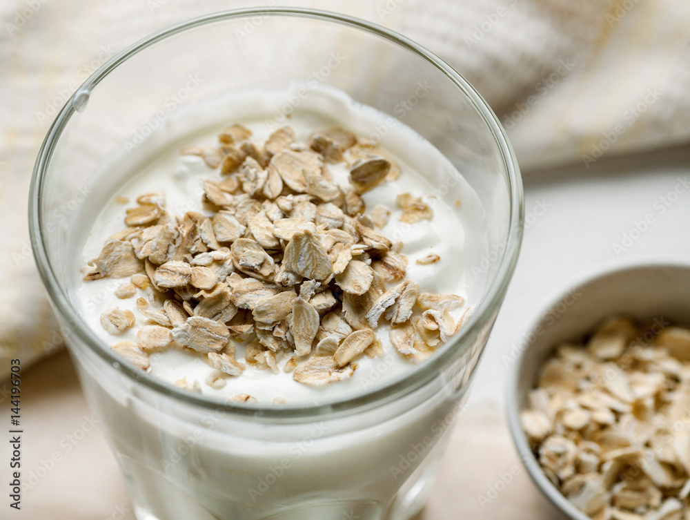 oat flakes in glass with yogurt closeup oat flakes in glass with yogurt closeup
