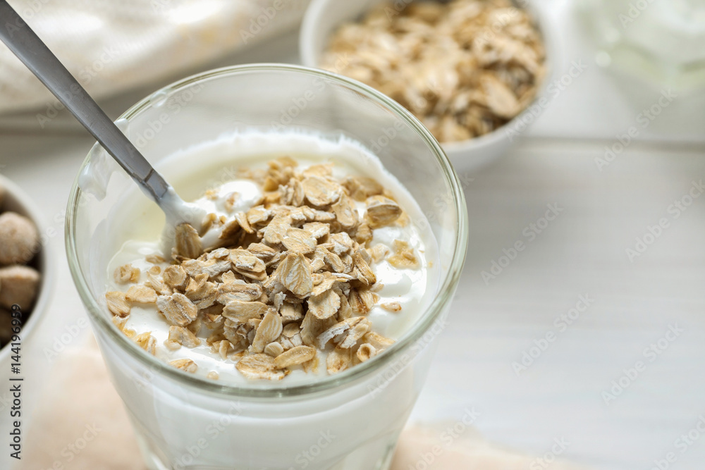 Healthy breakfast, smoothie with oat flakes on a white wooden table Healthy breakfast, smoothie with oat flakes on a white wooden table