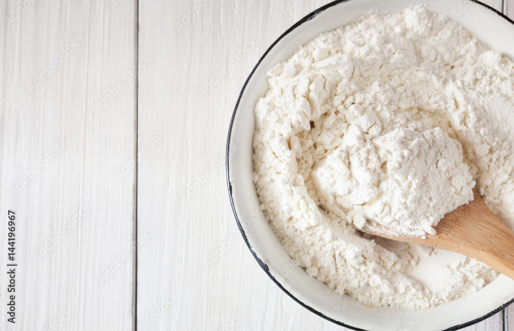 Making dough, baking. Bowl with flour on wood desk