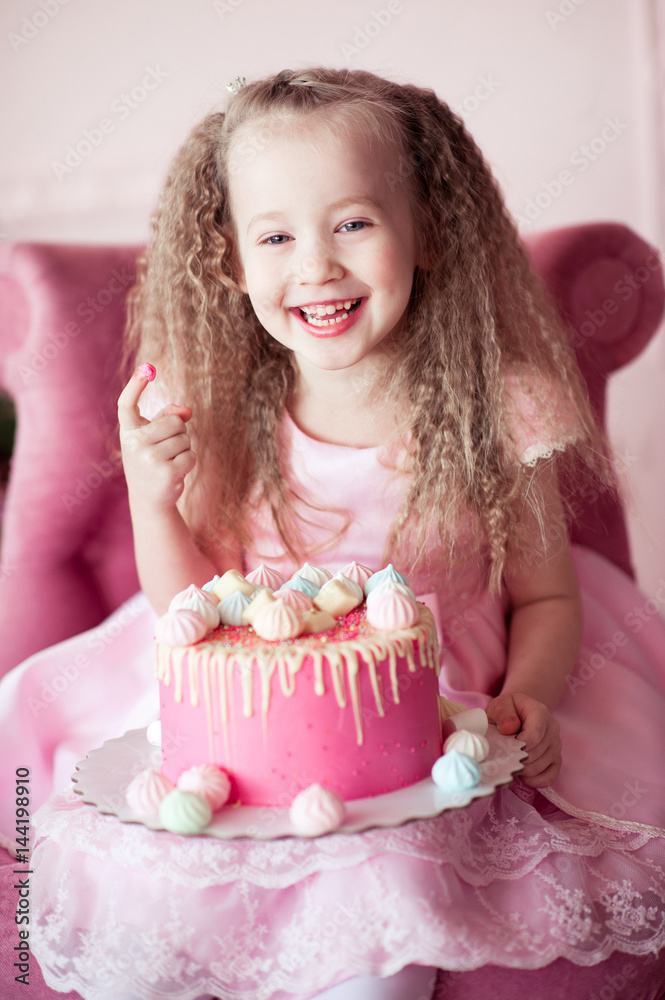 laughing-baby-girl-4-5-year-old-eating-birthday-cake-sitting-in-pink