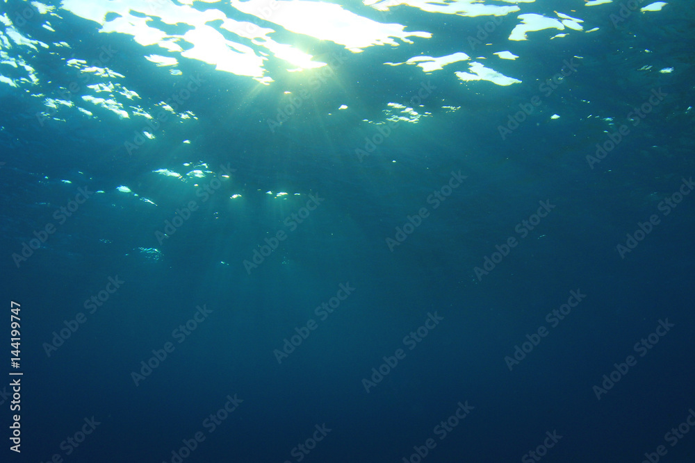 Underwater blue ocean background with sunlight 