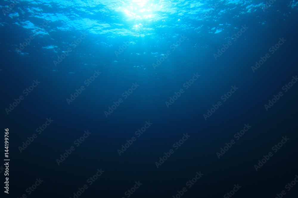 Underwater blue ocean background with sunlight 