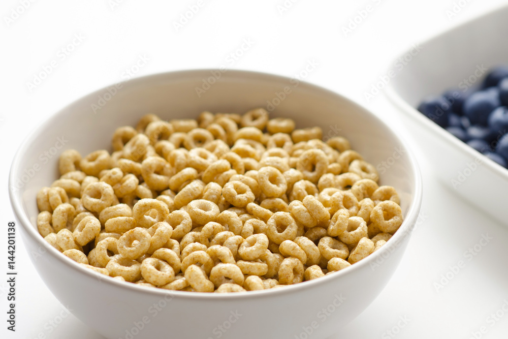 Bowl of cereal rings on white background close up