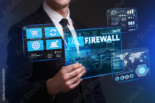 Business, Technology, Internet and network concept. Young businessman working on a virtual screen of the future and sees the inscription: Firewall photo
