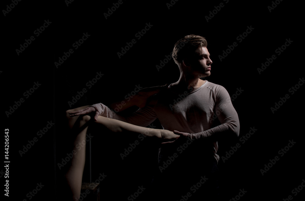 Handsome man posing with sexy naked female leg in hands