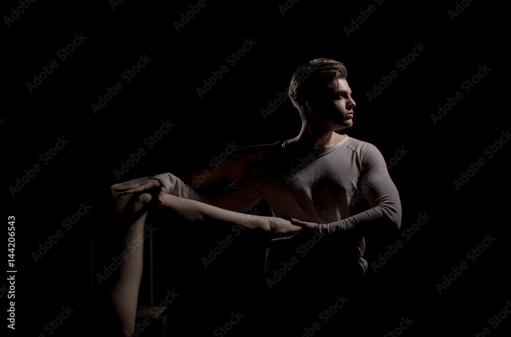 Handsome man posing with sexy naked female leg in hands Handsome man posing with sexy naked female leg in hands