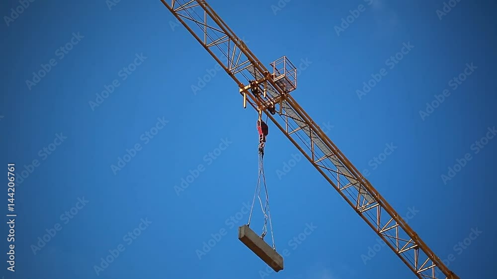 construction crane carries a concrete slab against the sky construction crane carries a concrete slab against the sky