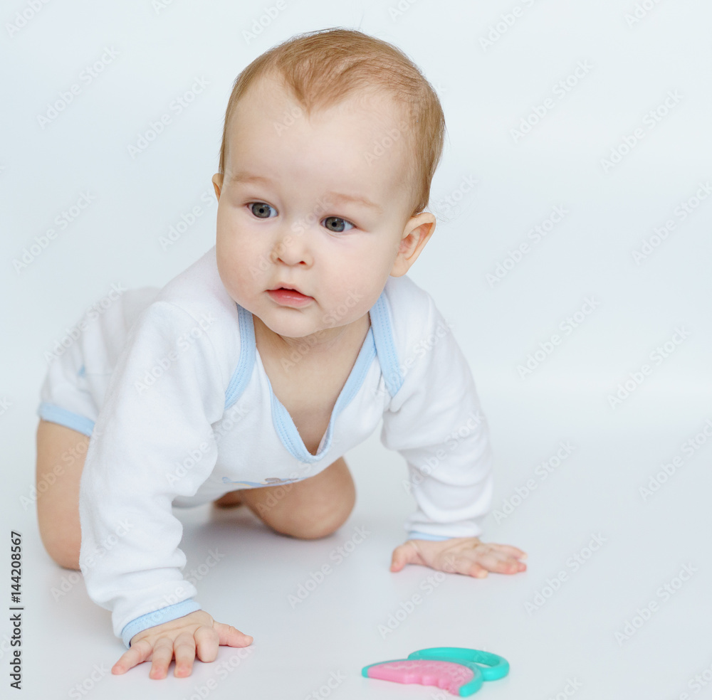 baby little child standing on all fours weared stretches to teether for teeth. baby little child standing on all fours weared stretches to teether for teeth.