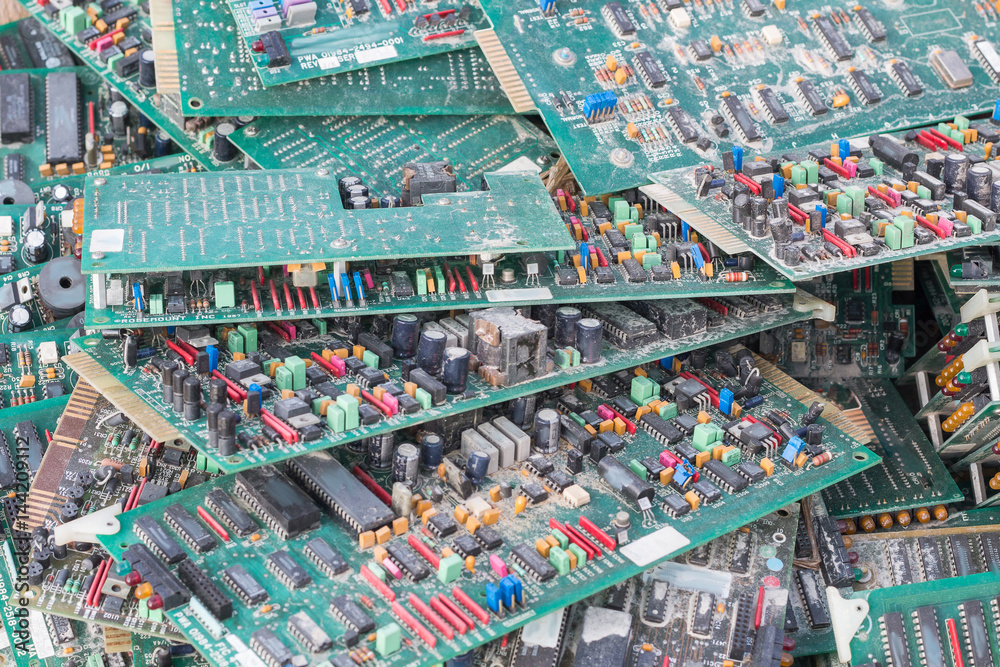 Fototapeta electronic card circuits garbage as background from recycle industry