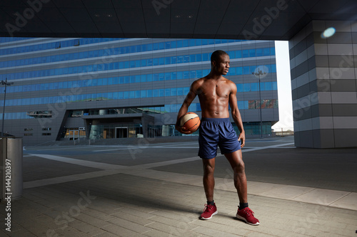 Portrait of afro american male basketball player with a ball