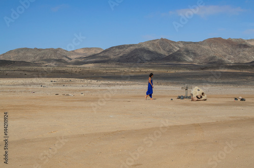 Woman in Blue in a Desert Landscape with Mountains near Swakopmund, Namibia