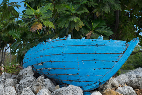 Derelict small blue Catboat on a roadside in the Caribbean, Grand Cayman, Cayman Islands