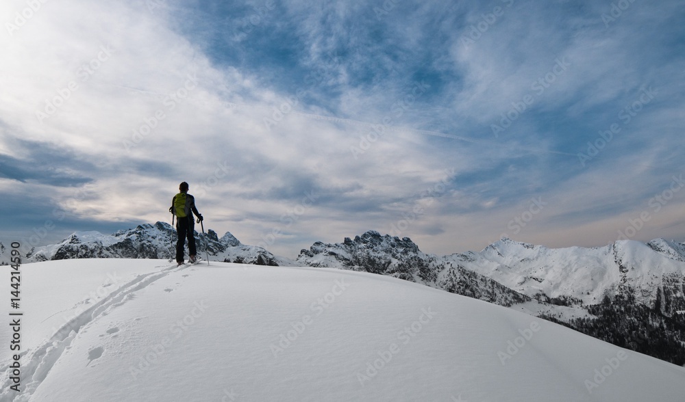 A girl skiing uphill in fresh snow in Valgerola, Valtellina, Italy,Alps A girl skiing uphill in fresh snow in Valgerola, Valtellina, Italy,Alps