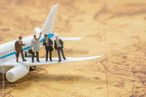 business miniature people on a plane