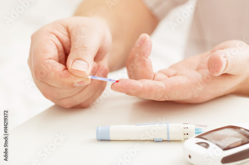 medicine  diabetes  glycemia  health care and people concept - close up of male finger with test stripe