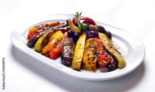 grilled vegetables on white plate with olives photo