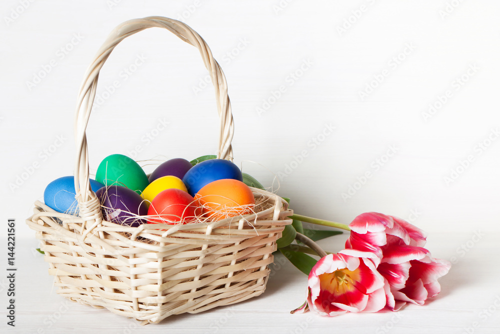 Naklejka premium Colored Easter eggs in a basket