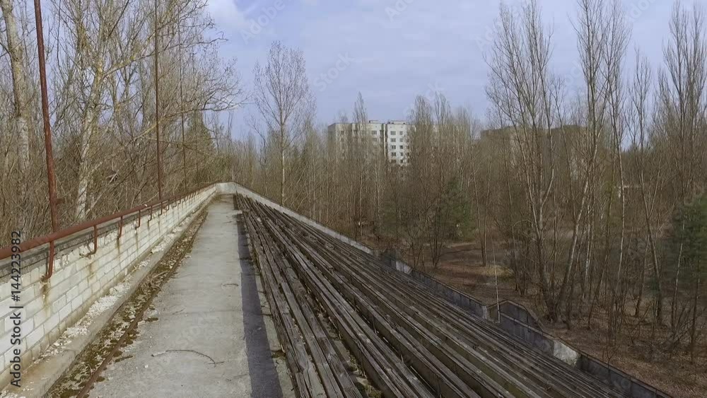 Ukraine, Pripyat, 6 april 2017: Crumbling tribunes of a sports stadium in the city of Pripyat Ukraine, Pripyat, 6 april 2017: Crumbling tribunes of a sports stadium in the city of Pripyat